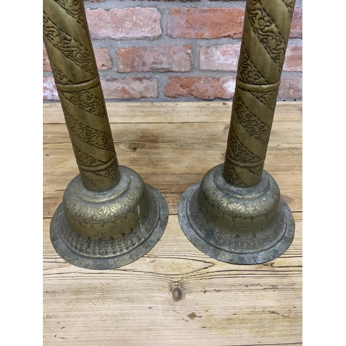 89 - Pair of large early 20th century Indian brass pricket candlesticks with scrolled engraved finish thr... 