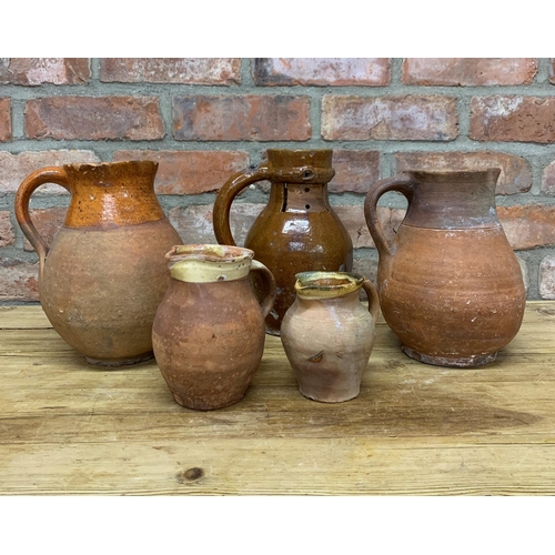 123 - Four antique 18th Somerset glazed earthenware pitcher jugs with additional glazed puzzle jug example... 