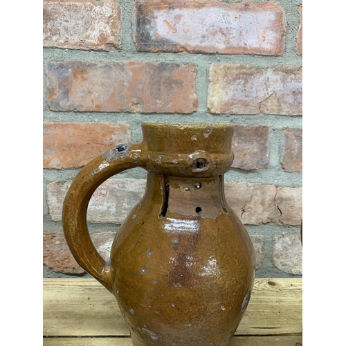 123 - Four antique 18th Somerset glazed earthenware pitcher jugs with additional glazed puzzle jug example... 