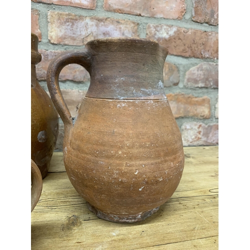 123 - Four antique 18th Somerset glazed earthenware pitcher jugs with additional glazed puzzle jug example... 