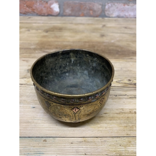 126 - Persian brass bowl with copper studded rim and lotus flower base, H 7cm x D 11cm