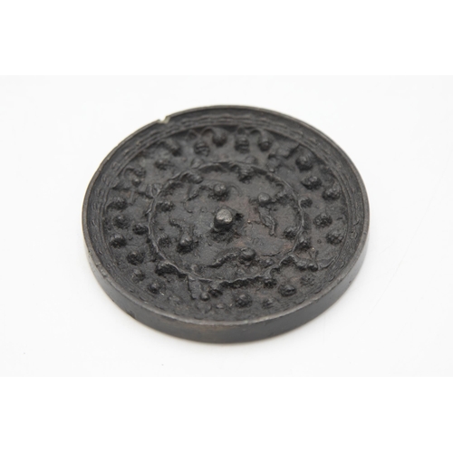 127 - Early Tang Dynasty Chinese bronze mirror, decorated with a scrolled animals and birds amongst grapev... 