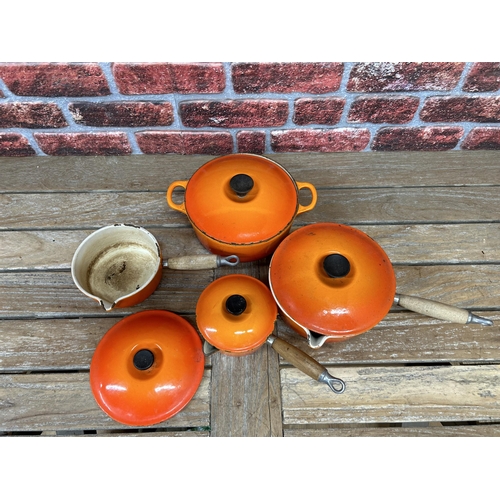 20 - Quantity of volcanic orange Le Creuset kitchenware to include saucepans and casserole dish