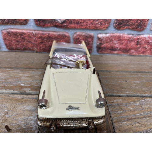 65 - Schuco Elektro-Radio tinplate model car with mint green/cream body, red interior and chrome trim, mo... 