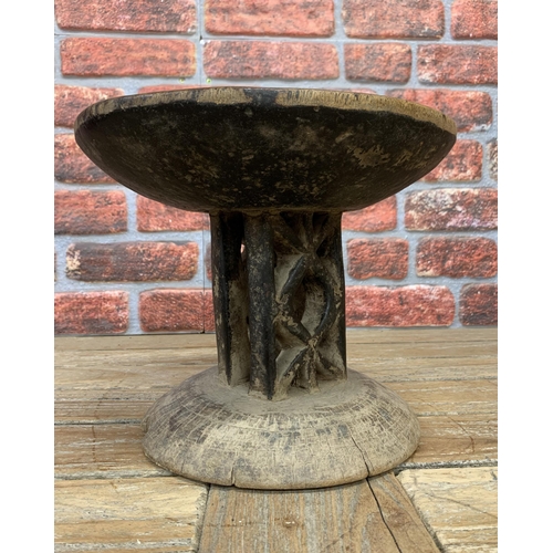 660 - Vintage Tongan tribal stool with dished seat upon twin geometric pierced columns, 24cm high x 28cm d... 