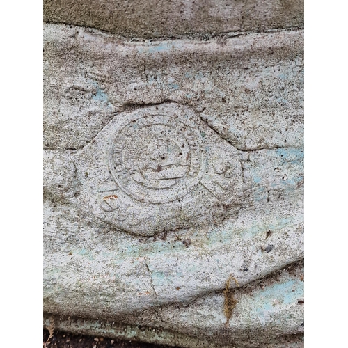 A weathered reconstituted stone three quarter length …