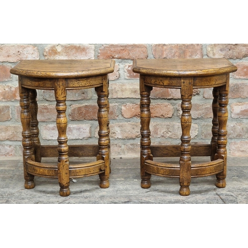 1071 - Pair of reproduction oak bow front stools raised on turned supports, H 48cm x W 38cm x D 33cm (2)