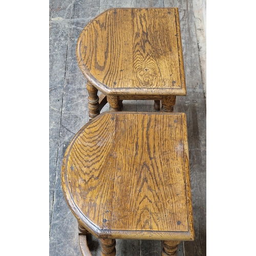 1071 - Pair of reproduction oak bow front stools raised on turned supports, H 48cm x W 38cm x D 33cm (2)