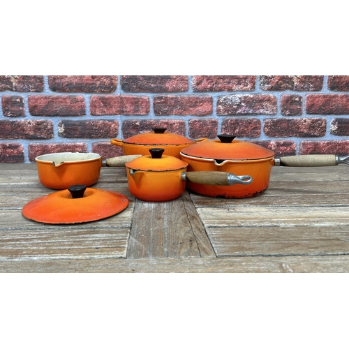 20 - Quantity of volcanic orange Le Creuset kitchenware to include saucepans and casserole dish