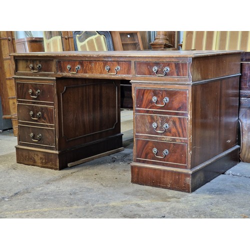 1001 - Antique mahogany twin pedestal desk with leather inset top, fitted with an arrangement of nine drawe... 