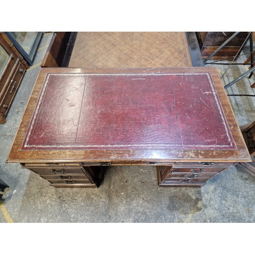 1001 - Antique mahogany twin pedestal desk with leather inset top, fitted with an arrangement of nine drawe... 