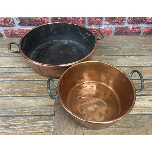 491 - Large antique polished copper twin handled cooking pot with further smaller example, largest D 44cm ... 