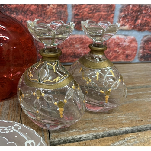 443 - Assortment of vintage glassware to include cranberry glass wine jug, hand painted scent bottles and ... 