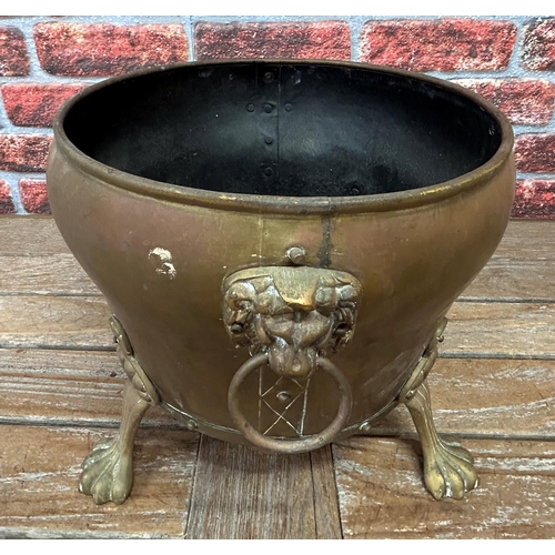 499 - Impressive copper and brass Victorian coal bucket, having lion paw feet and twin handled lion head h... 