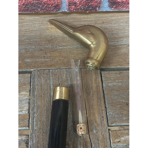 566 - Antique brass duck head topped three piece prohibition walking stick, with internal glass flask, L 9... 