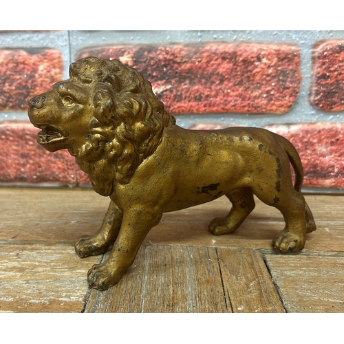 506 - Antique hollow cast bronze lion figure, painted gold finish, 22cm x 16cm