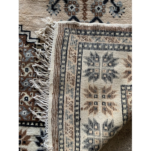 1591 - Large Bedouin style rug, bespoke geometric design on fawn ground, 294cm x 197cm