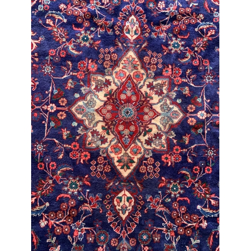 1619 - Large Hamadan carpet, intricate decoration on blue ground, 318cm x 215cm