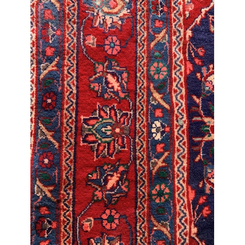 1619 - Large Hamadan carpet, intricate decoration on blue ground, 318cm x 215cm