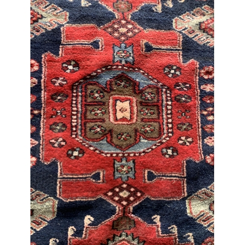 1622 - Full pile Persian village rug, red ground, 185cm x 120cm