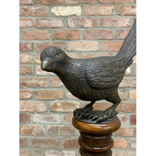 510 - Cast bronze sculpture of bird atop fluted mahogany torche column, 105cm