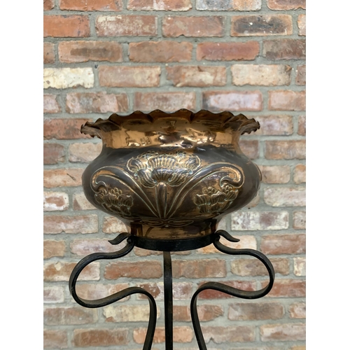 504 - Art Nouveau floral copper jardinière held atop decorative wrought iron stand, H 100cm