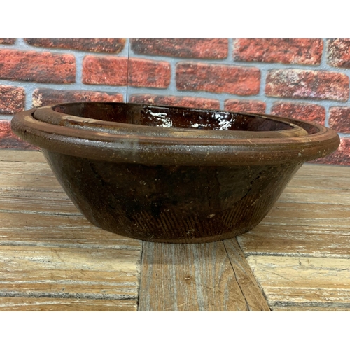 465 - Two graduated French antique treacle glazed terracotta dairy bowls, largest H 15cm x D 47cm