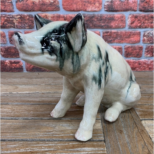 468 - Ex Butchers shop display black spotted Raku pottery pig, H 39cm x L 53cm