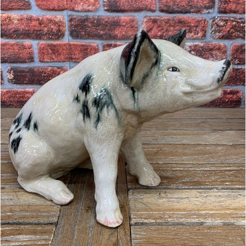 468 - Ex Butchers shop display black spotted Raku pottery pig, H 39cm x L 53cm