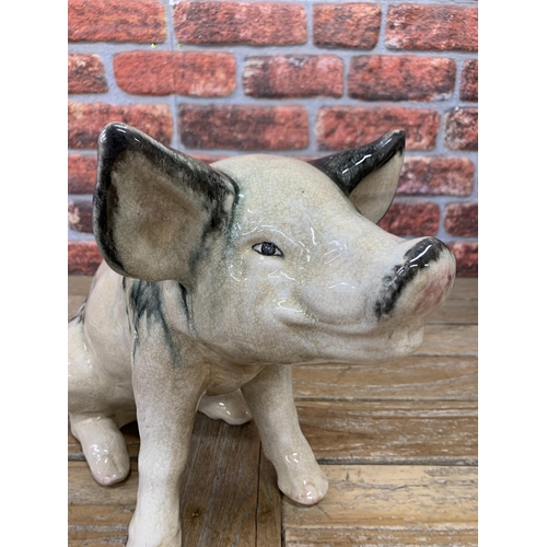 468 - Ex Butchers shop display black spotted Raku pottery pig, H 39cm x L 53cm