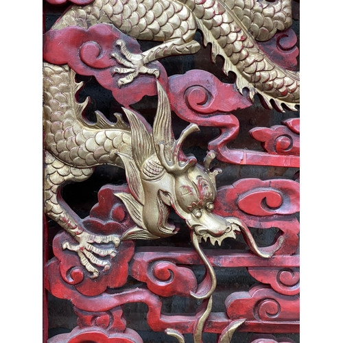 1240 - Large ornate Chinese cinnabar type red lacquered screen, pierced with gilt pearl chasing dragons, L ... 