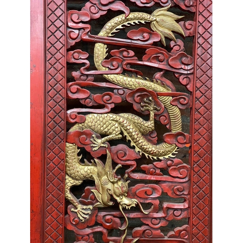 1240 - Large ornate Chinese cinnabar type red lacquered screen, pierced with gilt pearl chasing dragons, L ... 