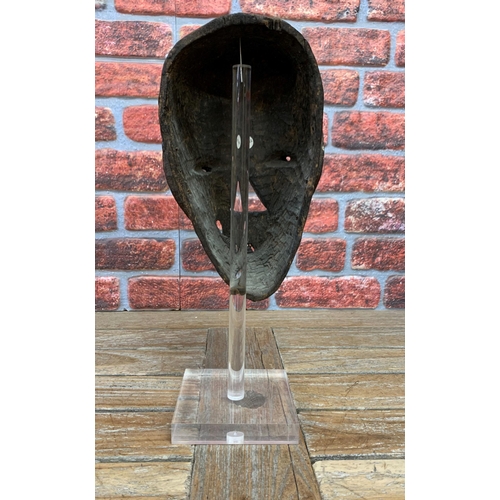 387 - West African tribal mask, pigment decoration, atop acrylic stand, H 47cm