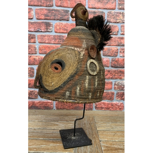 390 - Papua New Guinea helmet mask, pigment and feather decoration, atop metal stand, H 68cm