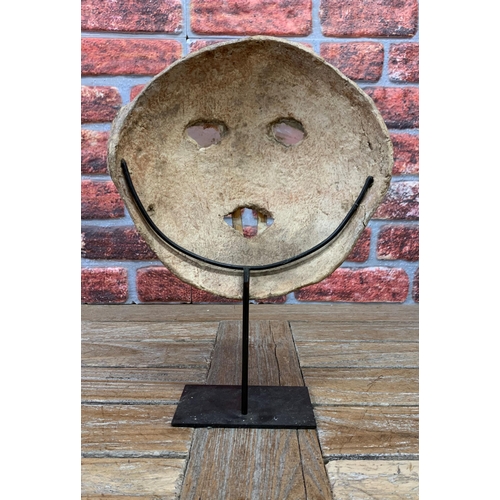 393 - Unusual Nepalese shaman mask, atop metal stand, H 39cm