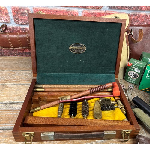 594 - Assortment of shooting related items to include leather gun slip, cartridge belts, Holland & Holland... 