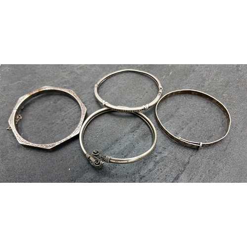 130 - Four silver bangles, two being hinged another with rams head details, 43.2g