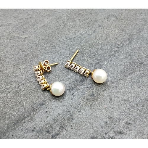 132 - Pair of gold diamond and pearl drop earrings, 25mm drop, 2.9g