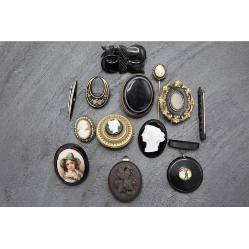 141 - Twelve pieces of mourning jewellery to include four cameos, pique crescent brooch, enamel brooch of ... 