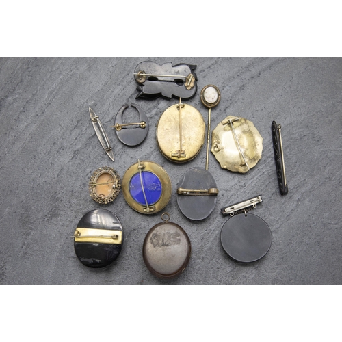 141 - Twelve pieces of mourning jewellery to include four cameos, pique crescent brooch, enamel brooch of ... 