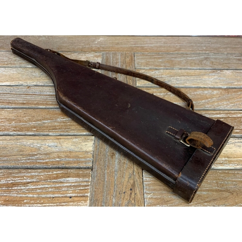 579 - Vintage brown leather 'leg of mutton' gun case with additional wooden example with fitted interior (... 