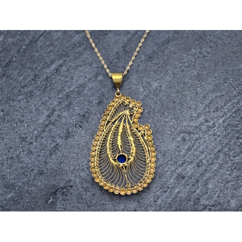 69 - Indian unmarked yellow metal peacock pheasant pendant on 9ct rope twist chain, chain 41cm long, 8.9g