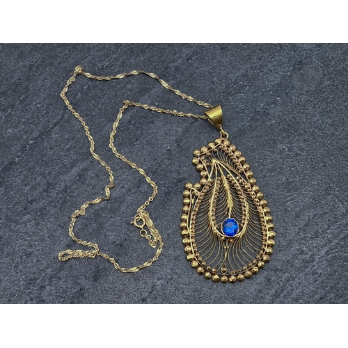 69 - Indian unmarked yellow metal peacock pheasant pendant on 9ct rope twist chain, chain 41cm long, 8.9g