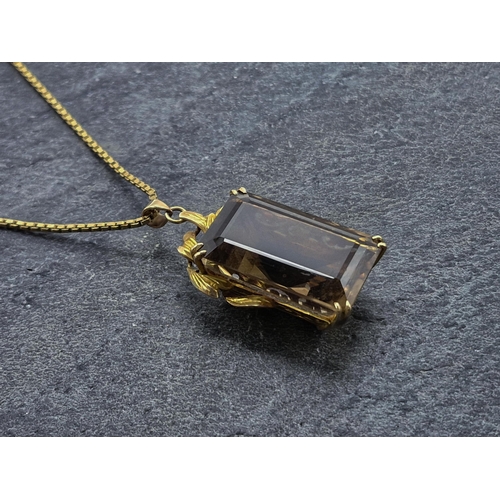 73 - Yellow metal and smoky quartz pendant, the bale marked 14k, on a 9ct chain, chain 62cm, 20.8g