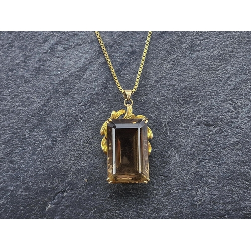 73 - Yellow metal and smoky quartz pendant, the bale marked 14k, on a 9ct chain, chain 62cm, 20.8g