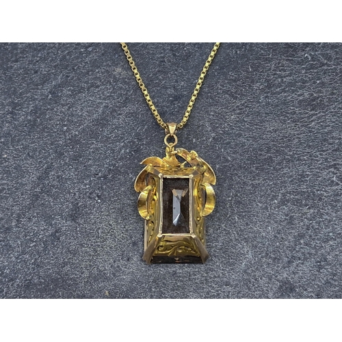 73 - Yellow metal and smoky quartz pendant, the bale marked 14k, on a 9ct chain, chain 62cm, 20.8g