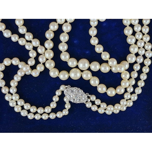 77 - Mid 20th century graduated double row pearl necklace with good diamond and platinum clasp, the clasp... 