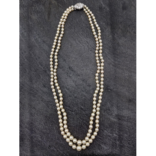 77 - Mid 20th century graduated double row pearl necklace with good diamond and platinum clasp, the clasp... 