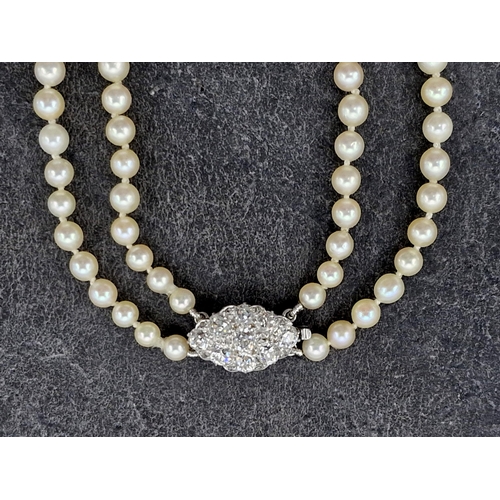 77 - Mid 20th century graduated double row pearl necklace with good diamond and platinum clasp, the clasp... 