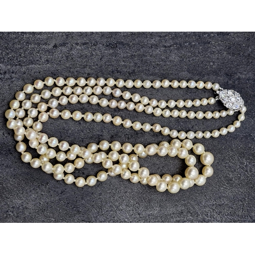 77 - Mid 20th century graduated double row pearl necklace with good diamond and platinum clasp, the clasp... 